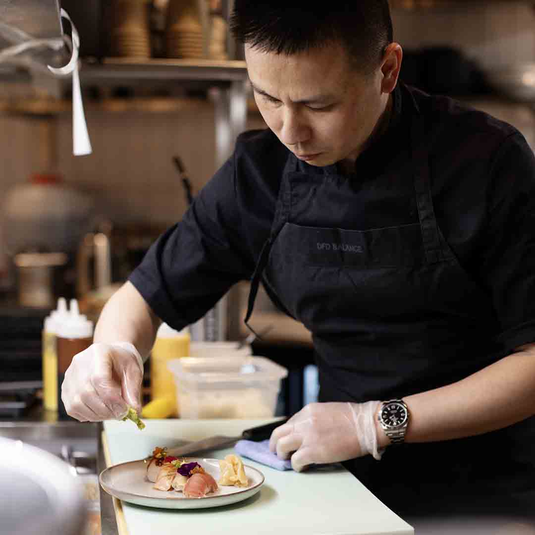 Sushi is being prepared by an employee from Sushi Lovers in Frederiksberg Center.